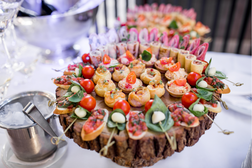 A buffet table displaying a variety of appetizers and drinks, inviting guests to enjoy a selection of refreshments.