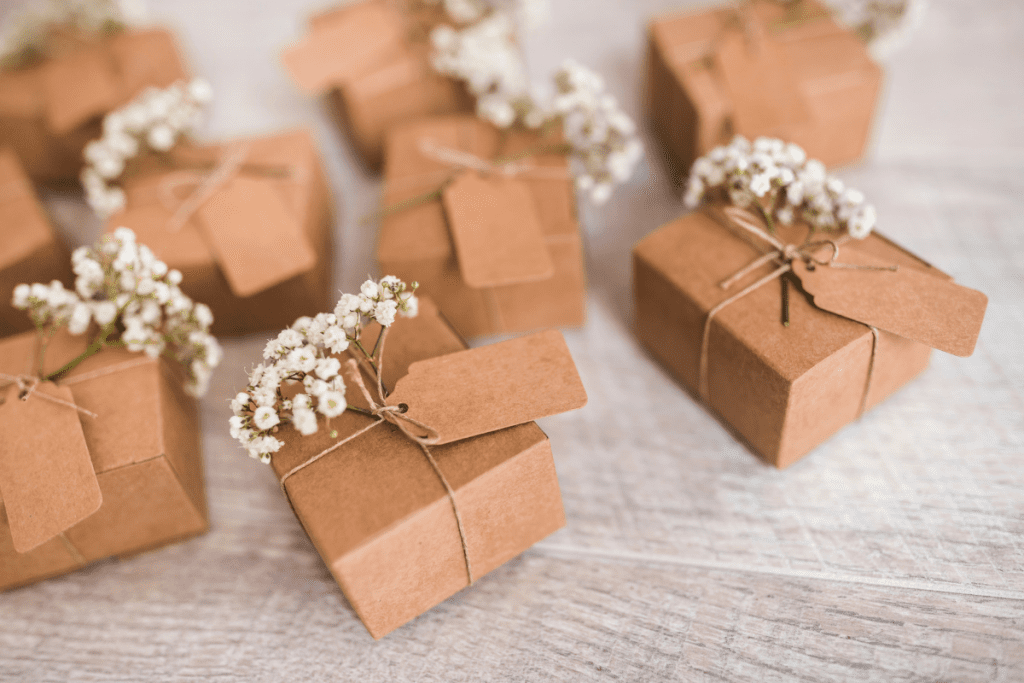 Small brown boxes adorned with delicate baby's breath flowers, creating a charming and rustic presentation.